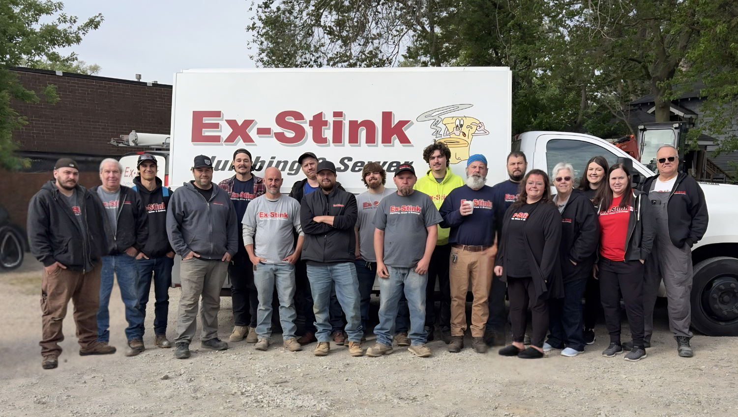 Ex-Stink Plumbing team in front of company truck